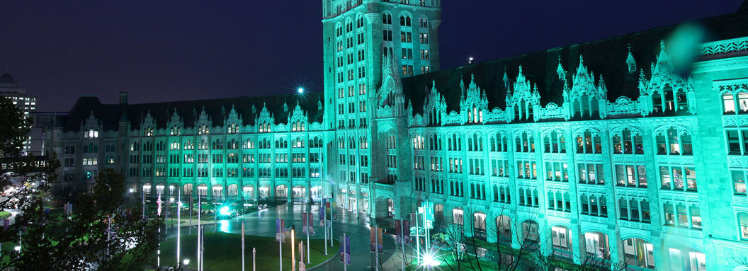 SUNY PLaza in Albany shines in green light on Veterans Day. 