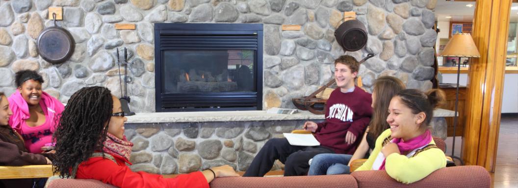 Potsdam students in lounge by fireplace