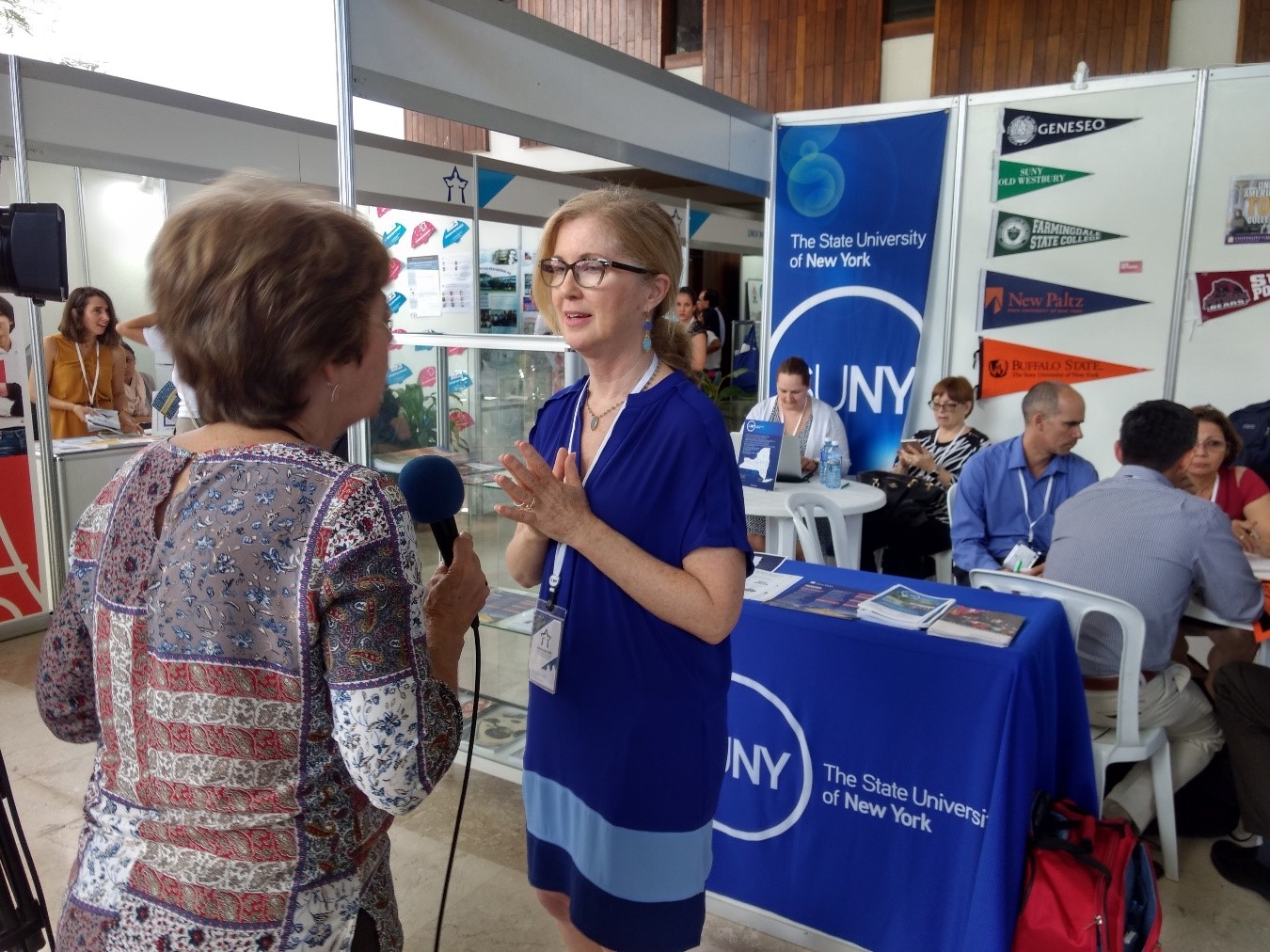 Cuban TV interview at SUNY booth in exhibit hall (Sally Crimmins Villela)