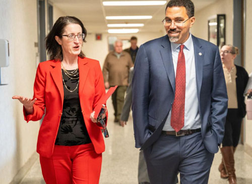 SUNY Chancellor John B. King Jr. walks with Herkimer County Community College president Terri Grates Day.